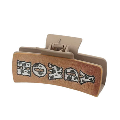 Nollia “Howdy” hair claw clip with western lettering on white background